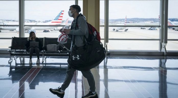 Travelers At Reagan Airport As Coronavirus Outbreak Continues To Spread